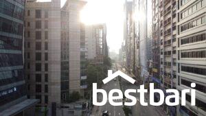 Empty early-morning city street in Bangladesh surrounded by tall commercial buildings, suitable for illustrating a List of Real Estate Company in Bangladesh.